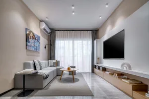 Modern residential interior with light-colored furniture, glass windows, and white accents.