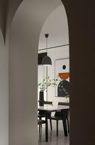 Modern dining room featuring a marble table and black chairs.