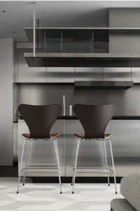 Modern industrial style kitchen with metal appliances and countertops.