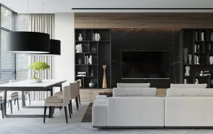 Modern living room featuring a white upholstered sofa, wooden accents, and open shelves with various decorative items.