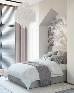 Modern bedroom interior featuring a white fabric bed, glass chandelier, and palm leaf wallpaper.