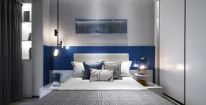 Modern bedroom featuring metallic accents and fabric upholstery, showcasing contemporary design elements.