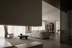 Modern minimalist living room with concrete elements and a comfortable sofa.