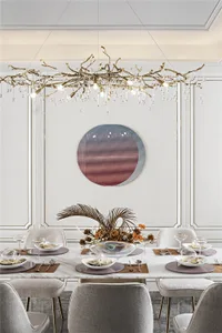 Modern dining table with marble top, grey upholstered chairs, and a unique hanging light fixture with geometric patterned wal