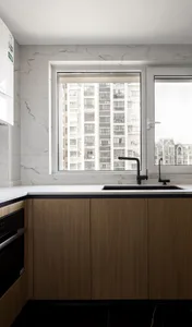 Modern kitchen with marble backsplash and black accents