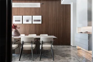 Modern dining room featuring a sleek marble table and chairs, with a wooden accent wall and white accents.