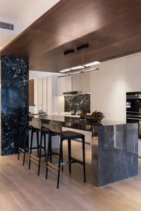 Modern kitchen with marble countertops and concrete floor
