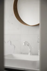 Modern bathroom interior designed with white marble tiles.