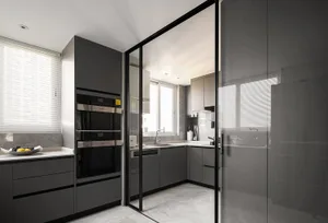 Modern kitchen featuring grey marble countertops and glass cabinets