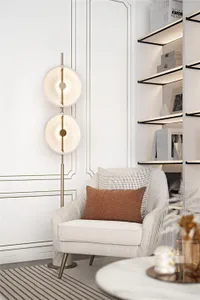 A modern living room featuring a contemporary armchair with soft textiles, illuminated by a stylish floor lamp.