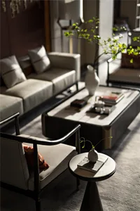 A modern living room with a leather couch, white coffee table, and decorative elements.