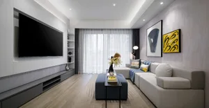Modern living room with textured walls, minimalist furniture, and large window.