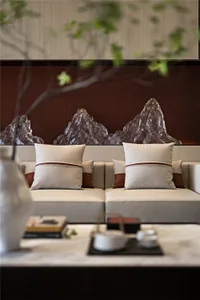 Modern minimalist living room with leather cushions and wooden backlit rock feature