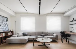 Modern living room with neutral tones and a minimalist design.