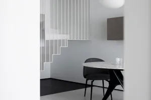 A minimalist interior featuring marble stairs and furniture.