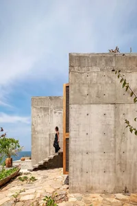 A modern concrete staircase with plants in a garden setting.