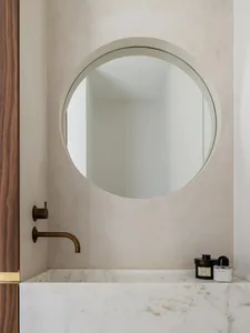A minimalist bathroom featuring a marble mirror and sink.
