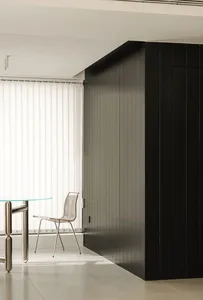 A modern office space featuring black glass paneling walls.