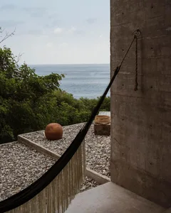 Concrete patio with industrial design elements and ocean view.