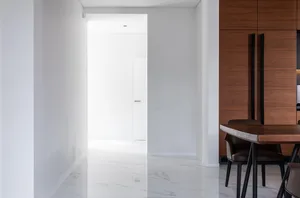Minimalist interior space featuring marble flooring.