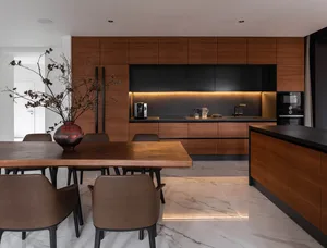A modern residential kitchen featuring wood accents and marble countertops.