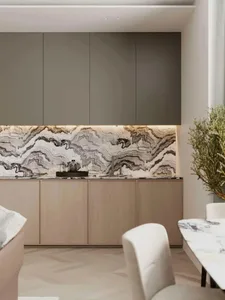 Modern kitchen with marble countertops and backsplash, wooden cabinets, and white seating.