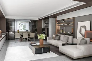Modern living room with concrete walls, minimalist furniture, and a sleek, contemporary design.