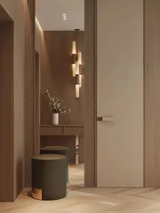 Modern entrance hallway with wooden paneling, a white door, and contemporary lighting fixtures.