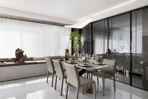 Modern dining room featuring a glass table and leather chairs, with minimalist design elements.