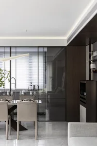 Modern dining room featuring glass, metal, and leather materials