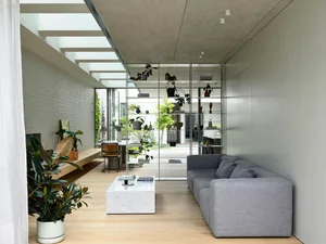Modern living room featuring minimalist design, concrete and glass elements