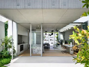 Modern residential kitchen featuring glass, concrete, and marble materials for contemporary design