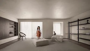 A minimalist living space featuring a child standing on a plush ottoman.