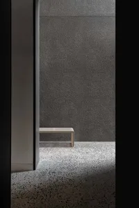 A minimalist interior designed using concrete and wool materials.