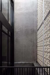 A modern building exterior showcasing industrial elements and geometric patterns in concrete.