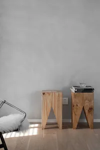 Two modern Scandinavian side tables made of light-colored wood in a living room setting.