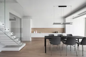 Modern kitchen featuring glass and metal elements with wooden accents