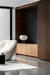 A modern living room featuring marble flooring and a wooden cabinet.