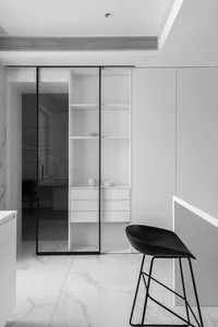 Modern minimalist kitchen featuring white marble countertops and metal accents