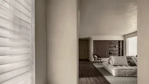 Modern minimalist living room with neutral-colored fabric, leather, and wood furniture.