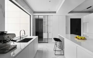 Modern, minimalist kitchen with white marble countertops and floor.