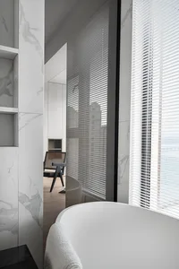 A modern marble bathroom features sleek, minimalist design and luxurious fixtures.