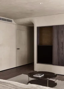 A modern minimalist living room featuring wood and concrete materials.