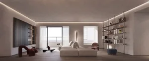 A modern, minimalist living room with concrete walls, a large window, and a sofa with a modern design.