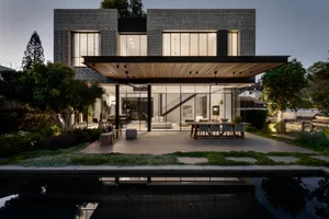 Modern residential building with brick exterior and large windows.