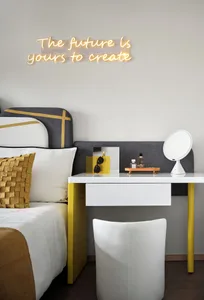 A modern bedroom featuring white concrete walls and a glass headboard.