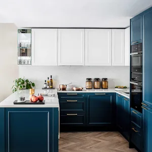 A modern kitchen with white countertops, black cabinets, and stainless steel appliances.