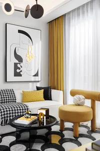 A modern living room with a white sofa, yellow cushions, and a black and white patterned rug. The room features a mustard yel