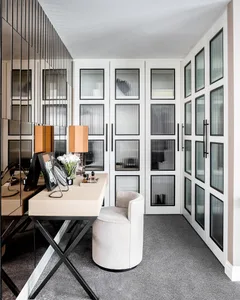 A modern office space featuring a white desk, steel details, and minimalist design.