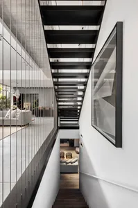 A modern residential staircase featuring black metal treads and railings.